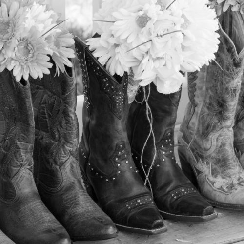 black and white wedding photo with cowgirl boots